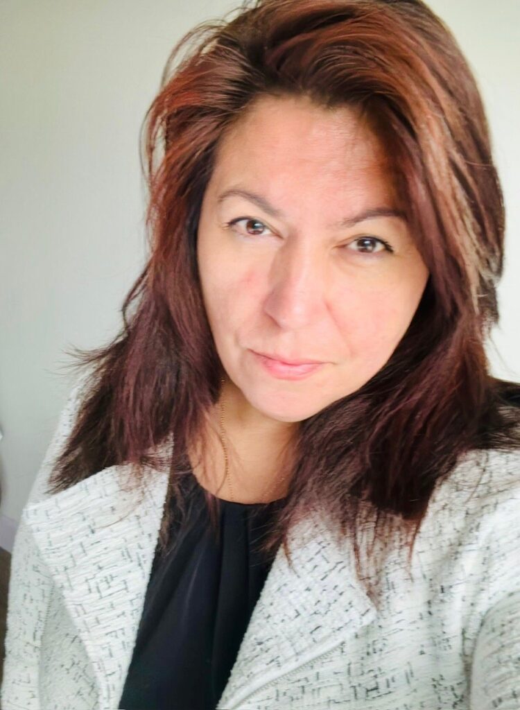Lawyers Against Transphobia National Conference: Educate! Advocate! Agitate! Pictured - A Cree-Métis person with a light complexion and shoulder-length brown hair, looking straight-on at the camera with an expression of determination.